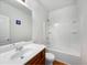 Bathroom with a shower and tub combo, single sink vanity and white tiling at 6100 Semaphore Rdg, Rex, GA 30273
