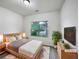 Comfortable bedroom with a large window providing natural light, complemented by soft, neutral tones at 6100 Semaphore Rdg, Rex, GA 30273