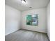 A cozy carpeted bedroom featuring a window that looks out onto a well-manicured lawn at 6100 Semaphore Rdg, Rex, GA 30273