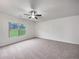 Bedroom featuring neutral carpeting, a ceiling fan, and a view to the outdoors at 6100 Semaphore Rdg, Rex, GA 30273