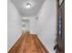 Inviting hallway featuring hardwood floors that leads to a bright, open living space at 6100 Semaphore Rdg, Rex, GA 30273