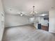Open-concept living room with plush carpeting, ceiling fan, and elegant chandelier at 6100 Semaphore Rdg, Rex, GA 30273