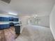 Open-concept living space with new carpet, kitchen with island, and abundant natural light at 6100 Semaphore Rdg, Rex, GA 30273