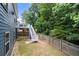 Spacious backyard featuring a wooden fence, upper level deck, and staircase leading down to the yard at 1536 Fenmore St, Lithia Springs, GA 30122