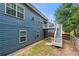 Back exterior view of the house featuring the deck and staircase at 1536 Fenmore St, Lithia Springs, GA 30122