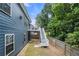 Spacious backyard featuring a wooden fence, upper level deck, and staircase leading down to the yard at 1536 Fenmore St, Lithia Springs, GA 30122