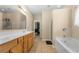 Bathroom with a double sink vanity, soaking tub, and glass enclosed shower at 1536 Fenmore St, Lithia Springs, GA 30122