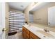 Bathroom with a double-sink vanity, bathtub, and shower featuring blue and white stripped shower curtain at 1536 Fenmore St, Lithia Springs, GA 30122