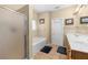 Bathroom featuring a tub, glass enclosed shower, and double sink vanity at 1536 Fenmore St, Lithia Springs, GA 30122