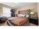 Bedroom with a large upholstered headboard, window with blinds, and side table at 1536 Fenmore St, Lithia Springs, GA 30122