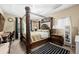 Bedroom featuring a four-poster bed with decorative trim and a striped accent rug at 1536 Fenmore St, Lithia Springs, GA 30122
