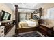 Bedroom featuring a four-poster bed, ceiling fan, and mounted television at 1536 Fenmore St, Lithia Springs, GA 30122