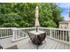 View of the backyard deck with white railings, umbrella, and furniture at 1536 Fenmore St, Lithia Springs, GA 30122