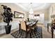 The dining room has an elegant chandelier and a decorative mirror at 1536 Fenmore St, Lithia Springs, GA 30122