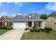 Charming home with a manicured lawn, featuring blue siding and a two-car garage at 1536 Fenmore St, Lithia Springs, GA 30122