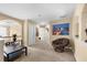 Upstairs hallway featuring a cozy chair, artwork, and neutral carpet at 1536 Fenmore St, Lithia Springs, GA 30122