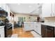 Modern kitchen with white cabinets, hardwood floors and stainless-steel appliances at 1536 Fenmore St, Lithia Springs, GA 30122