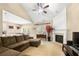 Cozy living room with vaulted ceilings, fireplace, large sectional sofa, and lots of natural light at 1536 Fenmore St, Lithia Springs, GA 30122