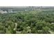 Aerial view showcasing the home surrounded by lush greenery with the city skyline in the distance at 2 W Muscogee Nw Ave, Atlanta, GA 30305