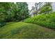 Expansive backyard featuring lush greenery and a partial view of the home's unique architecture at 2 W Muscogee Nw Ave, Atlanta, GA 30305