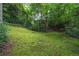 Beautiful backyard with moss ground cover, stone steps, and mature trees creating a serene, natural setting at 2 W Muscogee Nw Ave, Atlanta, GA 30305