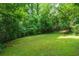 Expansive green backyard surrounded by mature trees and lush greenery at 2 W Muscogee Nw Ave, Atlanta, GA 30305