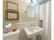 Bathroom with pedestal sink, wall-mounted mirror, and framed artwork at 2 W Muscogee Nw Ave, Atlanta, GA 30305