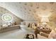 Cozy bedroom featuring floral wallpaper, round window, and comfortable cushioned seating area at 2 W Muscogee Nw Ave, Atlanta, GA 30305