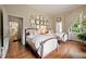 Bright bedroom with hardwood floors, twin beds, and a gallery wall of artwork at 2 W Muscogee Nw Ave, Atlanta, GA 30305