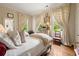 Comfortable bedroom featuring hardwood floors, natural light, and neutral decor at 2 W Muscogee Nw Ave, Atlanta, GA 30305
