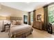 Comfortable bedroom featuring a bed, dresser and large windows, creating a cozy and inviting space at 2 W Muscogee Nw Ave, Atlanta, GA 30305