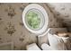 Close-up of a bedroom featuring a round window and floral wallpaper at 2 W Muscogee Nw Ave, Atlanta, GA 30305