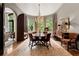 Elegant dining room featuring a round table, chandelier, and large windows with natural light at 2 W Muscogee Nw Ave, Atlanta, GA 30305