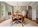 Inviting dining room featuring a round table, wood floors, and large arched entryway at 2 W Muscogee Nw Ave, Atlanta, GA 30305
