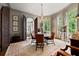Sophisticated dining room showcasing a crystal chandelier, round table and natural light from an arched window at 2 W Muscogee Nw Ave, Atlanta, GA 30305