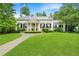 Elegant white home featuring a large lawn, columns, and classic shutters at 2 W Muscogee Nw Ave, Atlanta, GA 30305