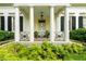 Up close image of front porch and ferns with columns and decorative ironwork at 2 W Muscogee Nw Ave, Atlanta, GA 30305