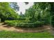 Beautiful formal garden with manicured hedges, gravel paths, and surrounding mature trees, providing a secluded oasis at 2 W Muscogee Nw Ave, Atlanta, GA 30305