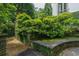 Unique garden with stone wall, lush green plantings, and a pea gravel walkway at 2 W Muscogee Nw Ave, Atlanta, GA 30305