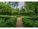 Stunning formal garden with manicured hedges, gravel pathways, mature trees, and vibrant greenery at 2 W Muscogee Nw Ave, Atlanta, GA 30305