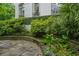 Charming garden terrace with stone paving, lush landscaping, and decorative wall planters at 2 W Muscogee Nw Ave, Atlanta, GA 30305