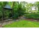 Backyard gazebo with stone steps and lush greenery, set against the backdrop of a stunning home at 2 W Muscogee Nw Ave, Atlanta, GA 30305