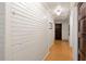 Hallway with wood paneling and view of several doorways, creating a cohesive and stylish design at 2 W Muscogee Nw Ave, Atlanta, GA 30305