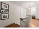 Upstairs hallway featuring hardwood floors, and natural light from a round window at 2 W Muscogee Nw Ave, Atlanta, GA 30305