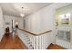 Upstairs hallway overlooking a bathroom featuring hardwood floors and natural light at 2 W Muscogee Nw Ave, Atlanta, GA 30305