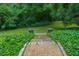 Stone steps lead to garden below with manicured hedges at 2 W Muscogee Nw Ave, Atlanta, GA 30305