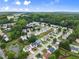 Picturesque aerial view of a residential community with tree-lined streets, well-kept homes, and a serene pond at 2530 Vistoria Dr, Cumming, GA 30041
