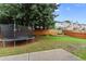 Serene backyard with a lush green lawn, a trampoline, and a charming garden area, ideal for Gathering fun at 2530 Vistoria Dr, Cumming, GA 30041