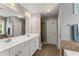 Spacious bathroom boasts a double vanity and tiled floor and shower at 2530 Vistoria Dr, Cumming, GA 30041