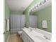 Bathroom with double vanity, large mirror, and shower/tub combo with neutral wall color at 2530 Vistoria Dr, Cumming, GA 30041